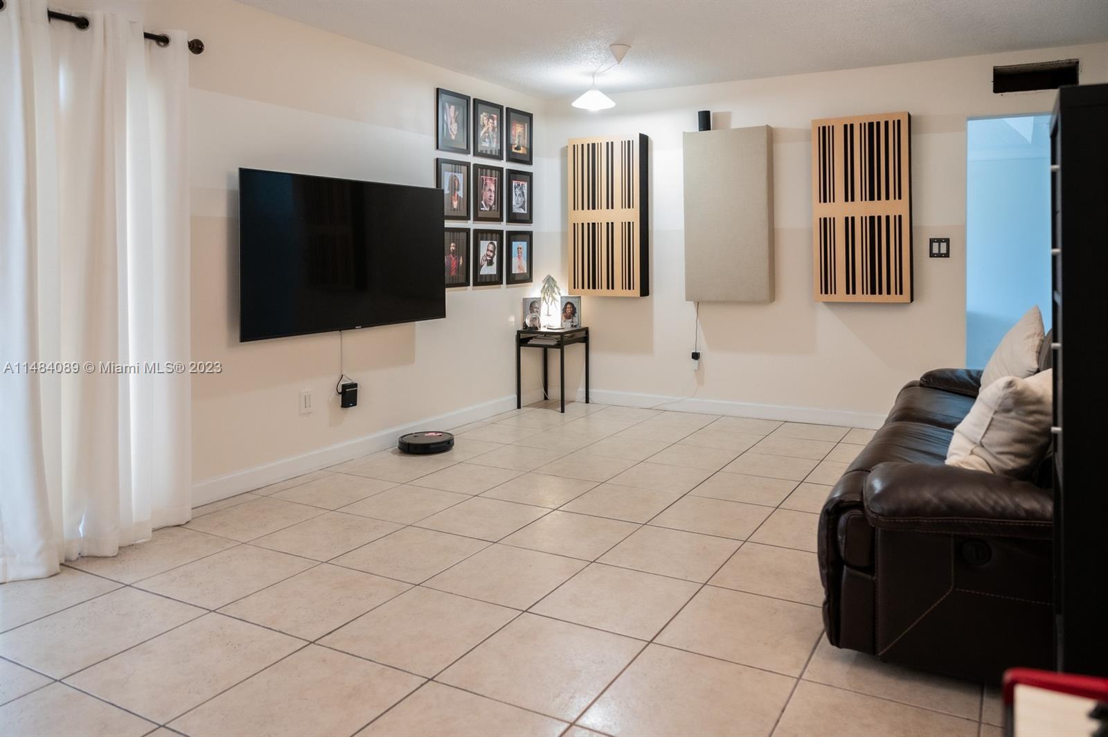 7715 Southwest 86th Street, Unit A2307 Miami, FL 33143 - Photo 22 of 89 a living room with furniture and a flat screen tv