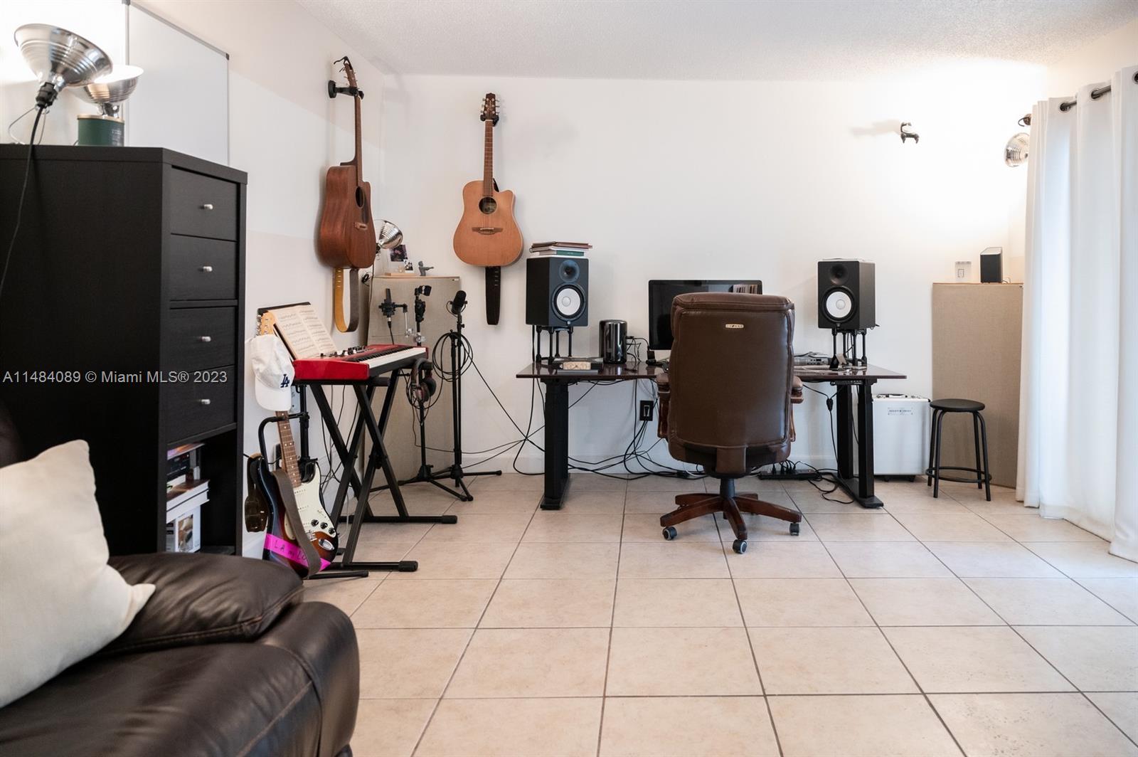7715 Southwest 86th Street, Unit A2307 Miami, FL 33143 - Photo 24 of 89 a view of a livingroom with furniture and gym equipment