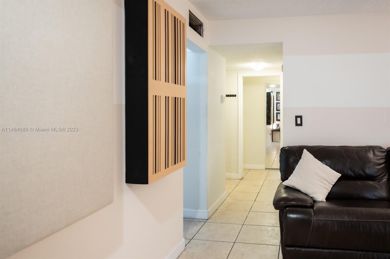 7715 Southwest 86th Street, Unit A2307 Miami, FL 33143 - Photo 25 of 89 a living room with furniture and a gate