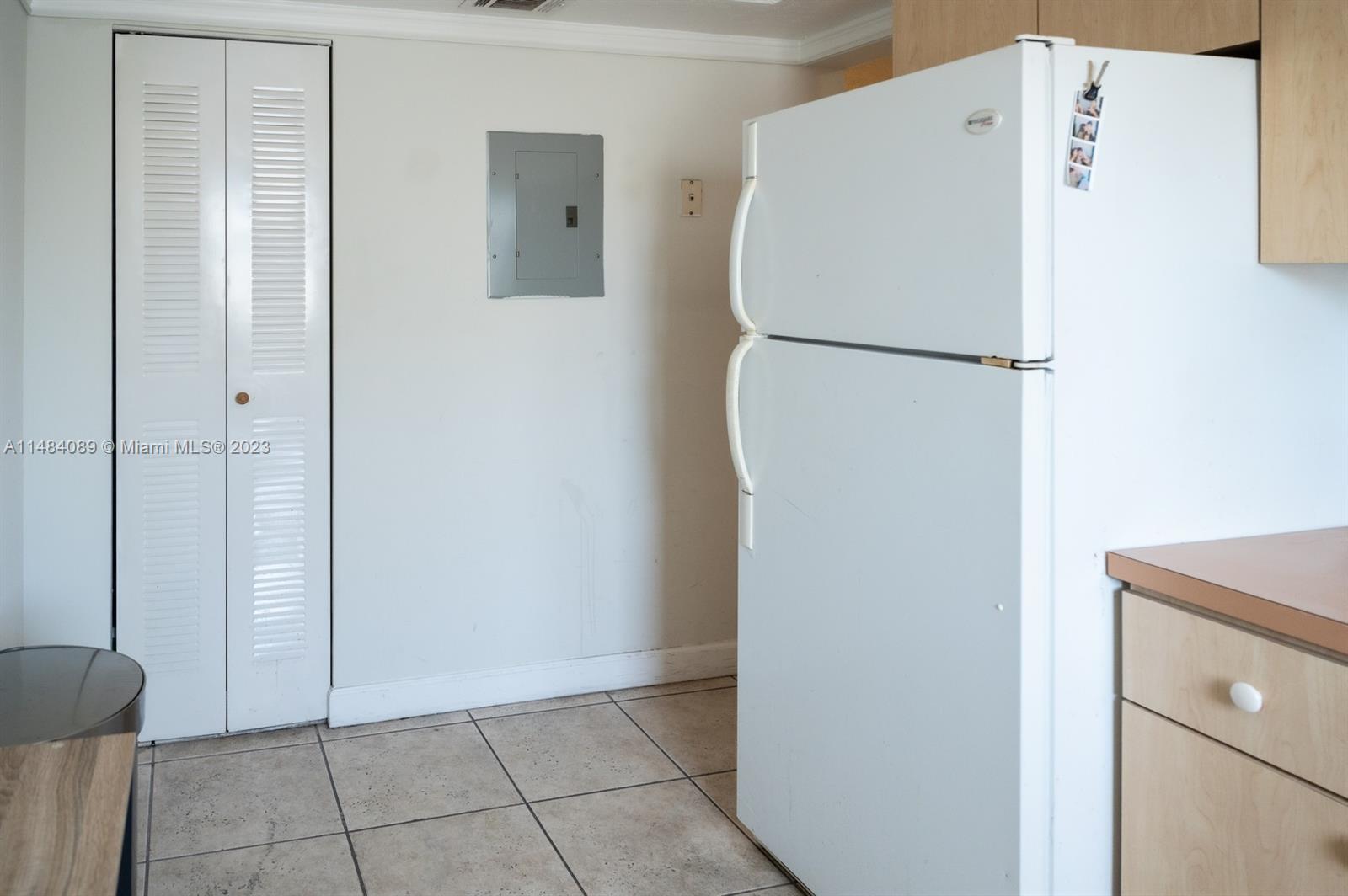 7715 Southwest 86th Street, Unit A2307 Miami, FL 33143 - Photo 31 of 89 a white refrigerator freezer and a stove sitting inside of a kitchen