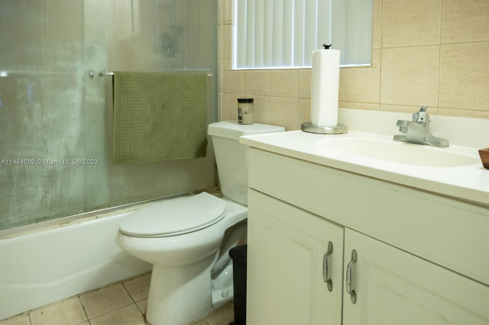 7715 Southwest 86th Street, Unit A2307 Miami, FL 33143 - Photo 37 of 89 a bathroom with a sink a toilet and shower