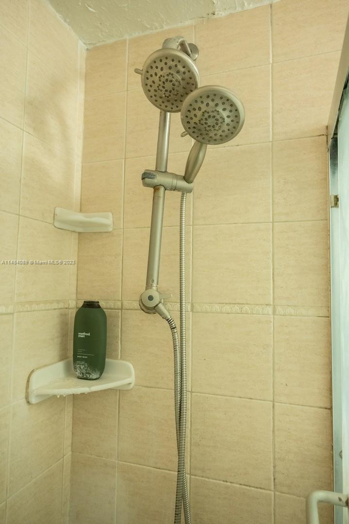 7715 Southwest 86th Street, Unit A2307 Miami, FL 33143 - Photo 38 of 89 a bathroom with a shower