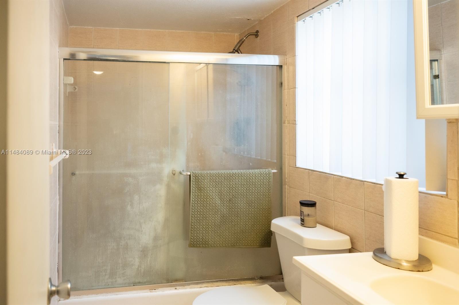 7715 Southwest 86th Street, Unit A2307 Miami, FL 33143 - Photo 40 of 89 a bathroom with a shower and a sink