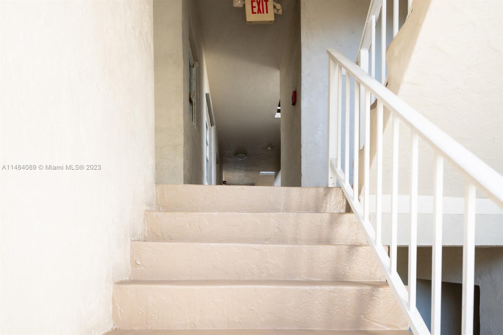 7715 Southwest 86th Street, Unit A2307 Miami, FL 33143 - Photo 4 of 89 a view of staircase with white walls