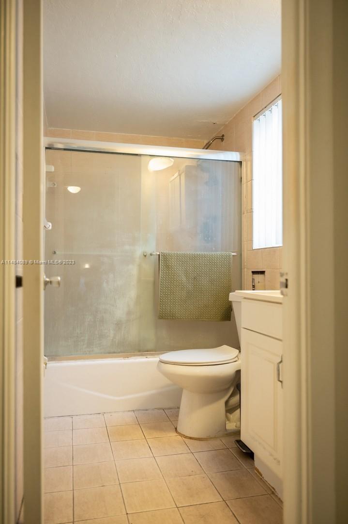 7715 Southwest 86th Street, Unit A2307 Miami, FL 33143 - Photo 42 of 89 a bathroom with a toilet and a shower