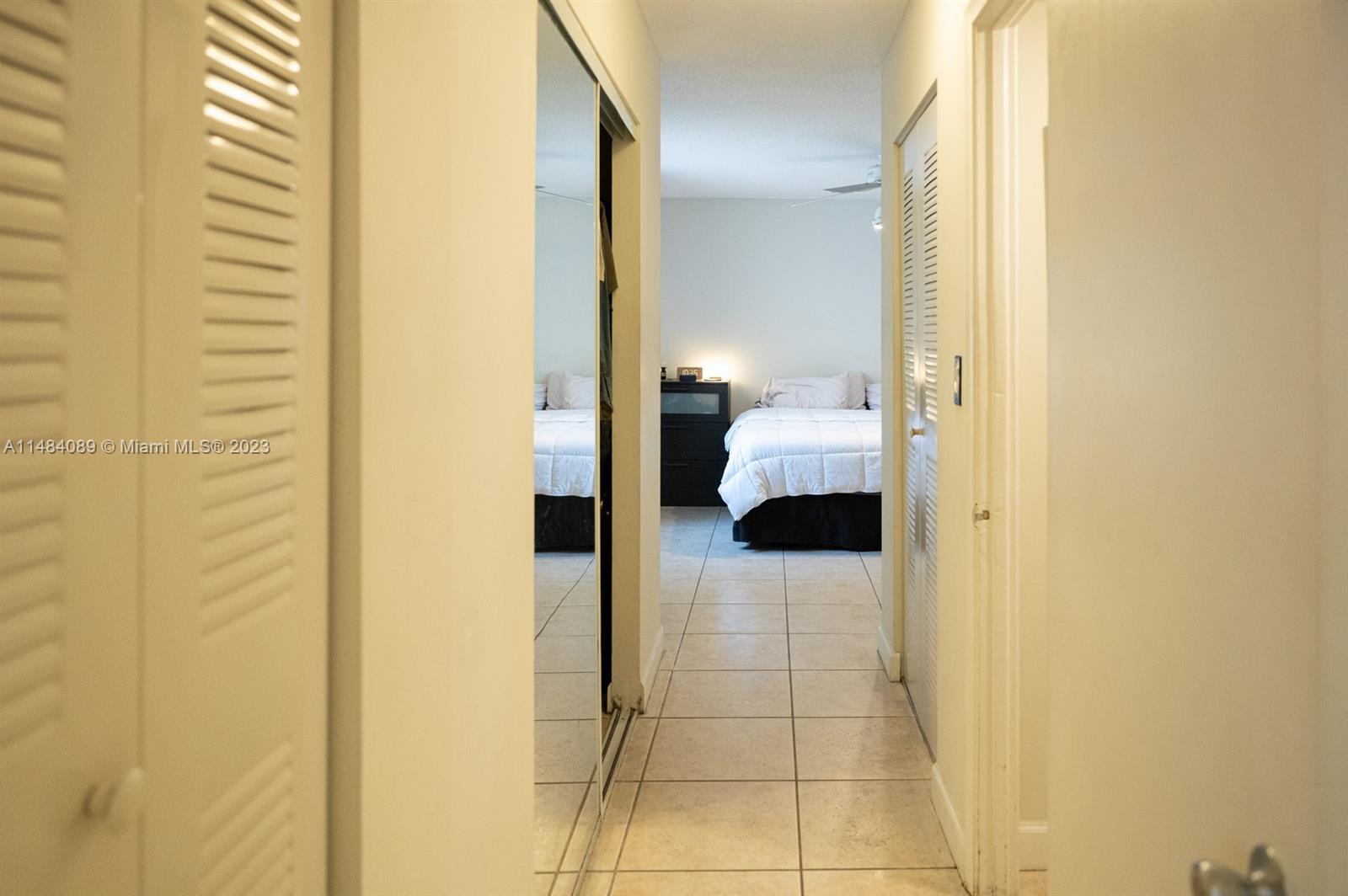 7715 Southwest 86th Street, Unit A2307 Miami, FL 33143 - Photo 45 of 89 a bathroom with a glass shower door