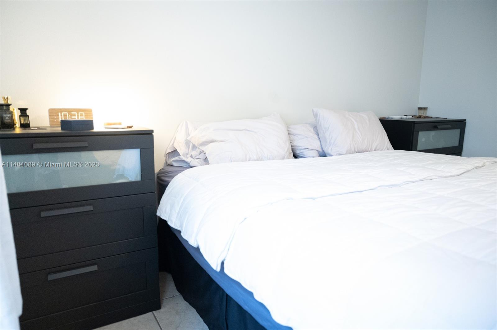 7715 Southwest 86th Street, Unit A2307 Miami, FL 33143 - Photo 55 of 89 a bedroom with a bed and a dresser