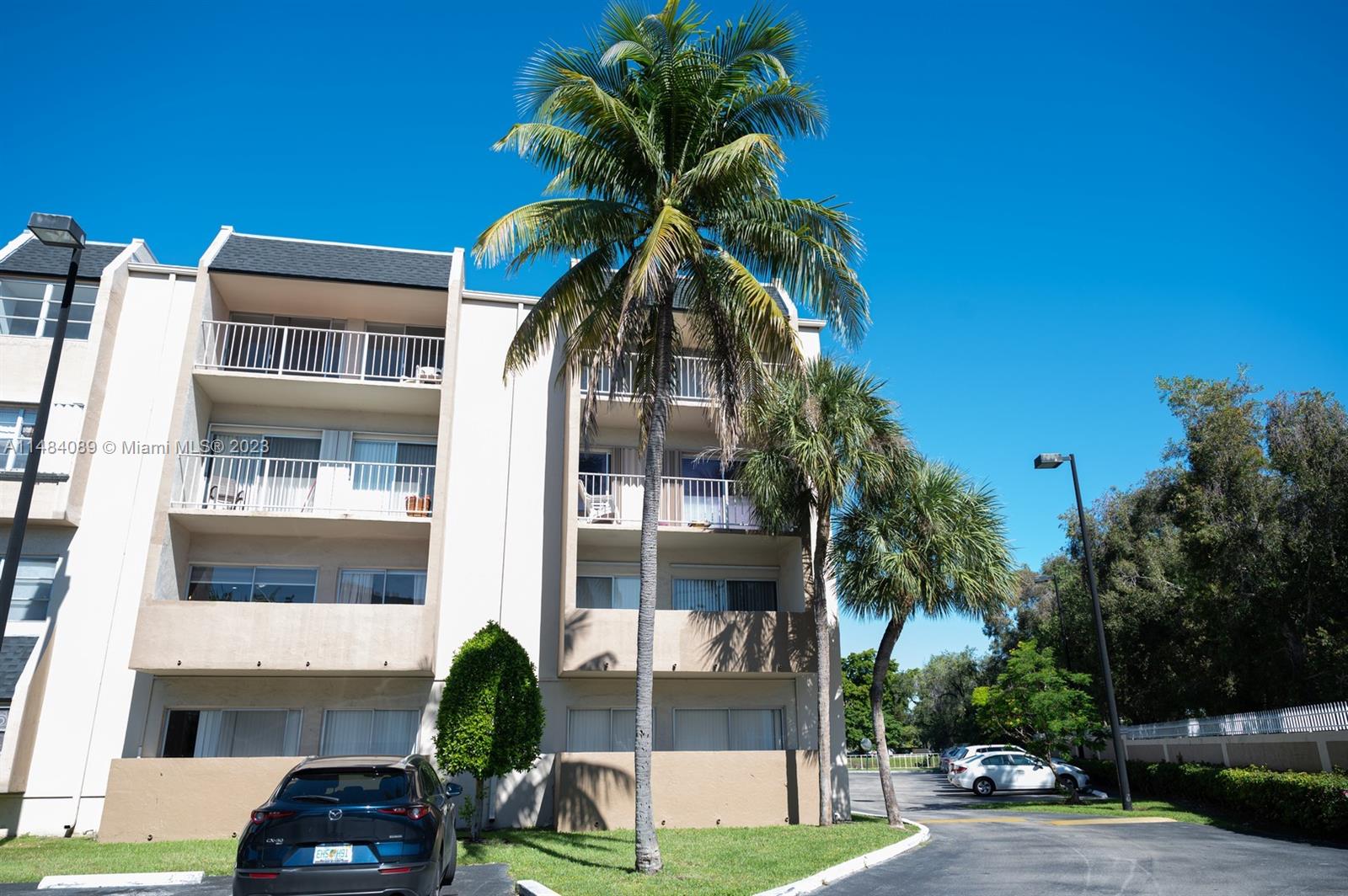 7715 Southwest 86th Street, Unit A2307 Miami, FL 33143 - Photo 58 of 89 a front view of a house with a garden