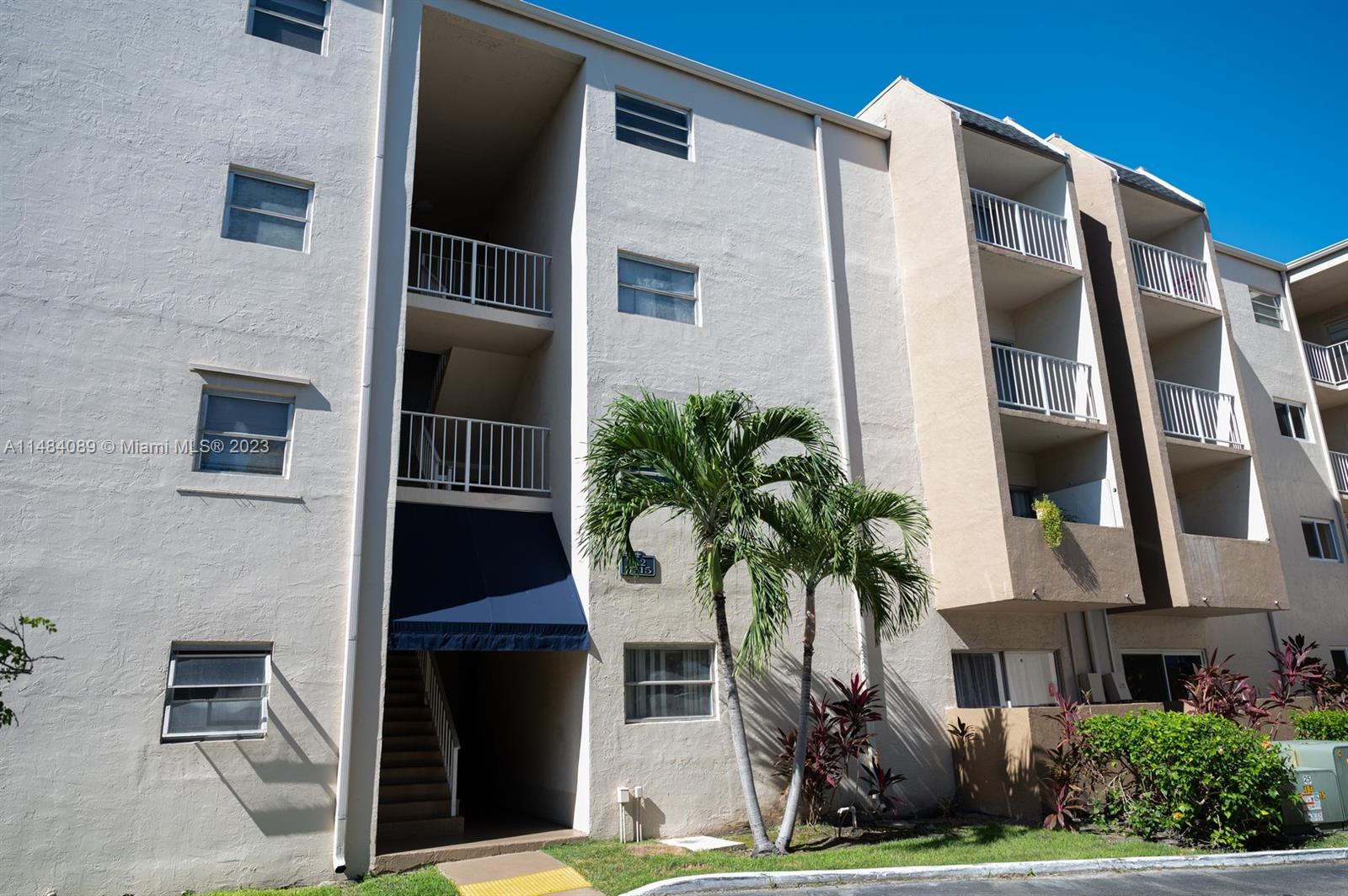 7715 Southwest 86th Street, Unit A2307 Miami, FL 33143 - Photo 60 of 89 a front view of building with yard