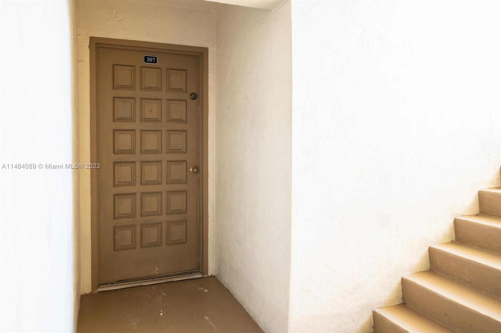 7715 Southwest 86th Street, Unit A2307 Miami, FL 33143 - Photo 6 of 89 a view of front door with wooden floor