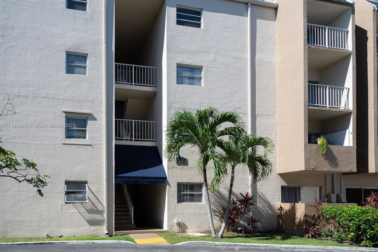 7715 Southwest 86th Street, Unit A2307 Miami, FL 33143 - Photo 62 of 89 a front view of a house with a garden