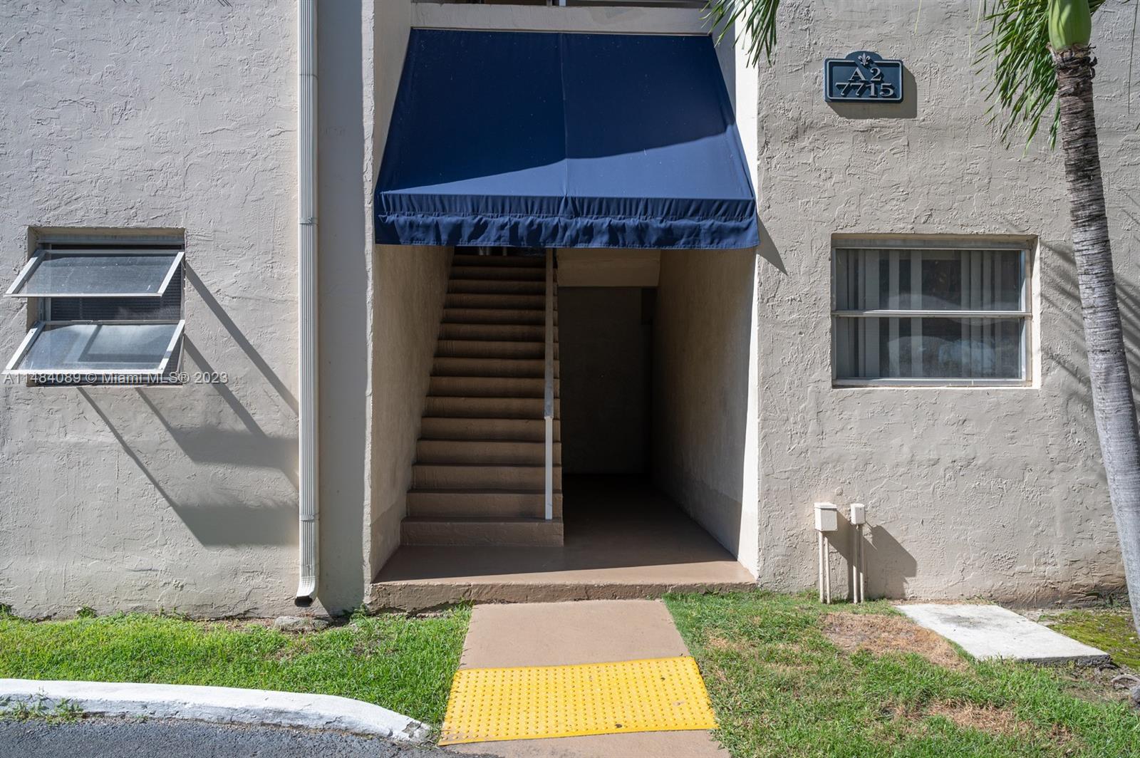 7715 Southwest 86th Street, Unit A2307 Miami, FL 33143 - Photo 66 of 89 a front view of a house with a yard