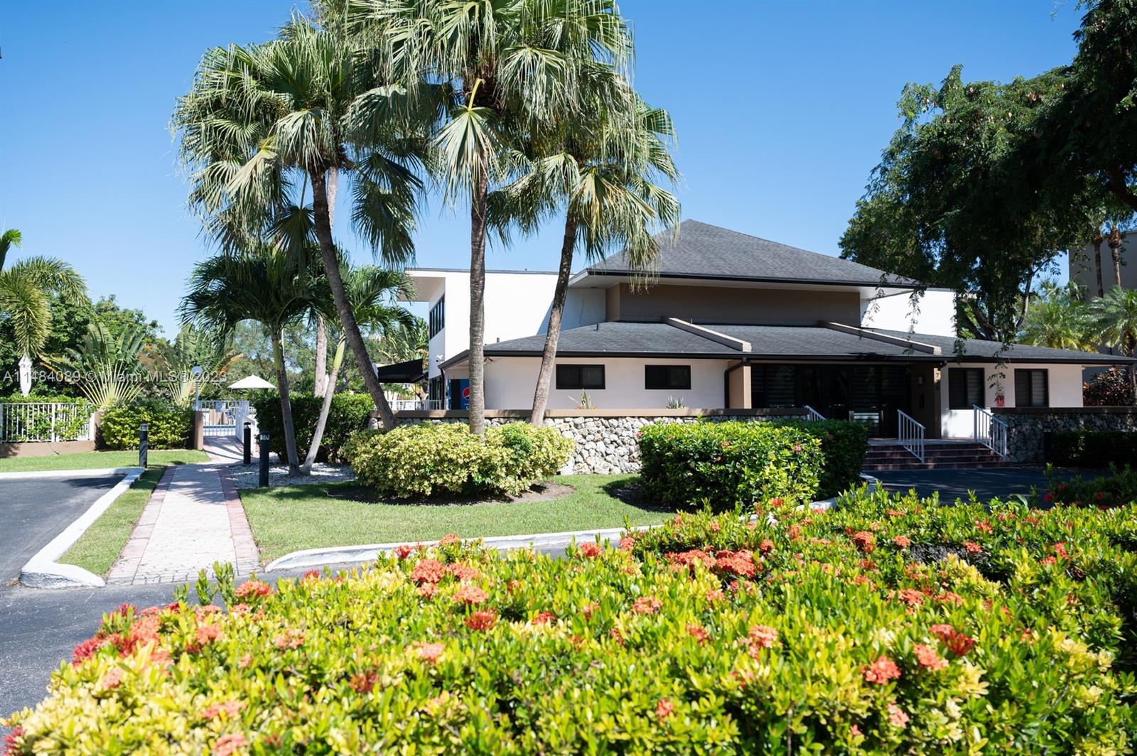 7715 Southwest 86th Street, Unit A2307 Miami, FL 33143 - Photo 77 of 89 a front view of a house with a yard