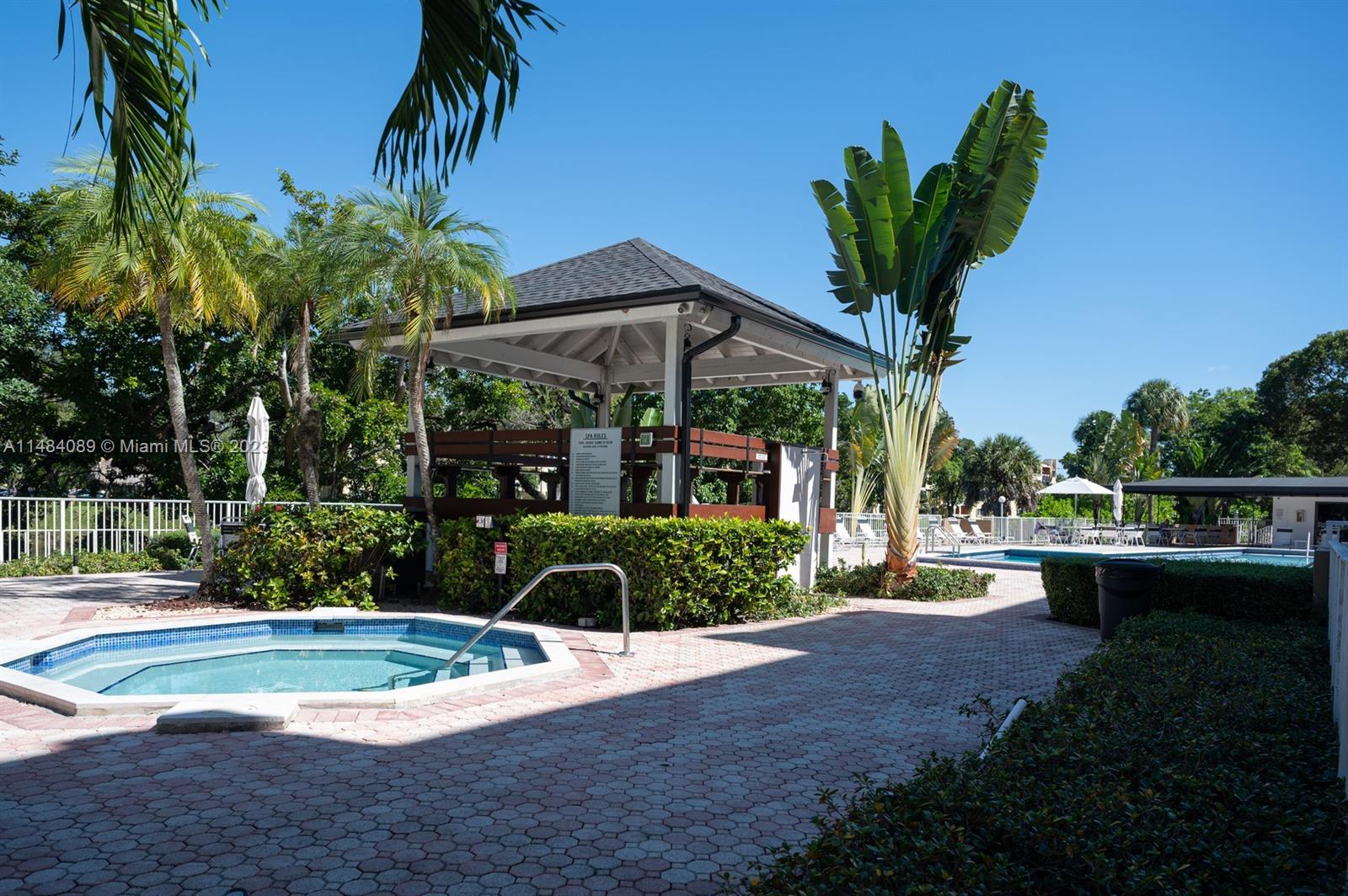 7715 Southwest 86th Street, Unit A2307 Miami, FL 33143 - Photo 83 of 89 a front view of a house with a yard and potted plants