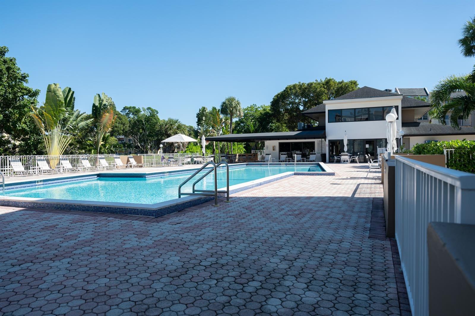 7715 Southwest 86th Street, Unit A2307 Miami, FL 33143 - Photo 84 of 89 a view of a swimming pool with an outdoor seating