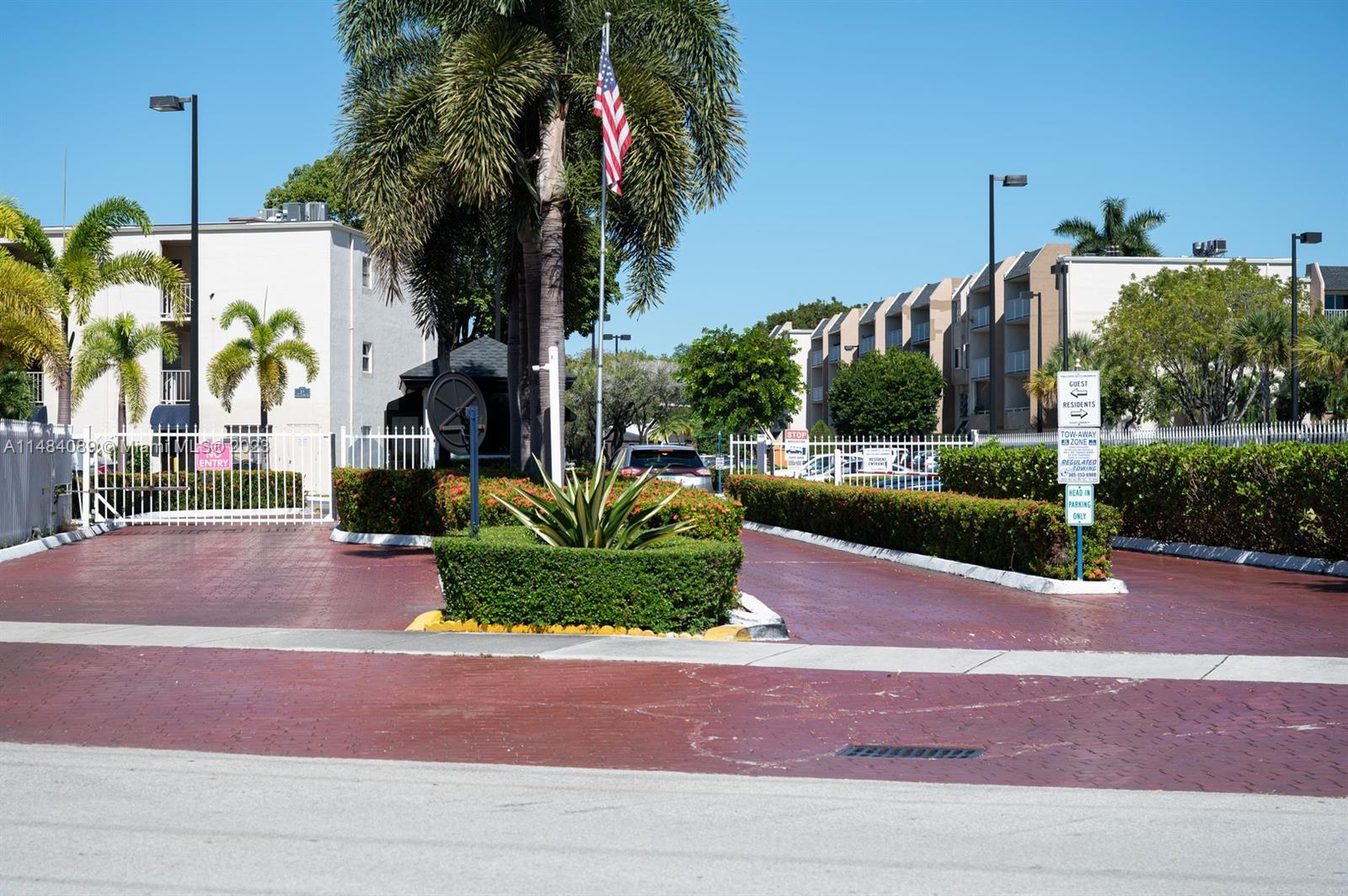 7715 Southwest 86th Street, Unit A2307 Miami, FL 33143 - Photo 89 of 89 a palm tree sitting in front of a house with a yard