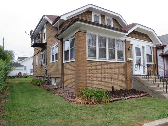 2040 Carter Street Racine, WI 53402 - Photo 2 of 19 a front view of a house with a garden