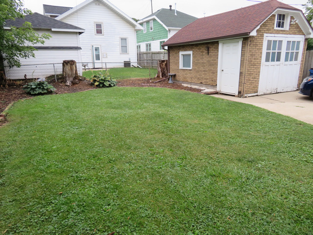 2040 Carter Street Racine, WI 53402 - Photo 3 of 19 a front view of a house with a garden and trees