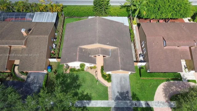 an aerial view of a house with a garden and plants