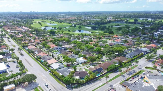 an aerial view of residential houses with outdoor space
