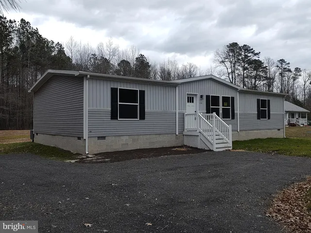 a view of a house with backyard space and wooden fence