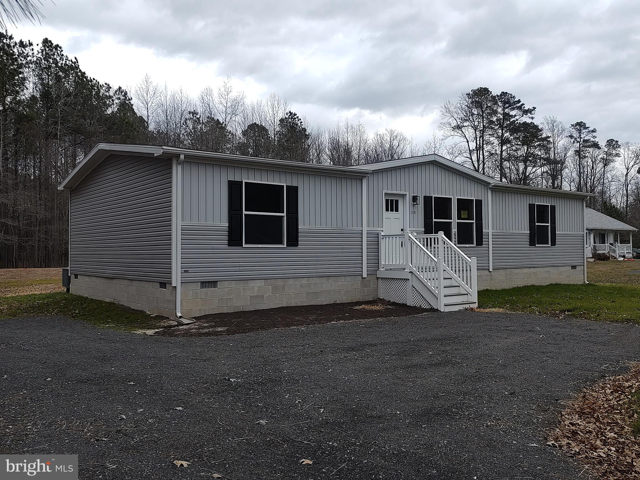 22525 Cedar Lane Georgetown, DE 19947 - Photo 3 of 24 a view of a house with backyard space and wooden fence