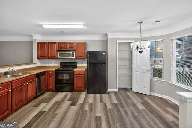 a kitchen with stainless steel appliances granite countertop a refrigerator stove and sink
