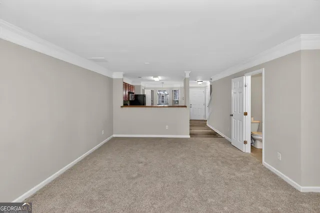 a view of a kitchen with a sink and a refrigerator