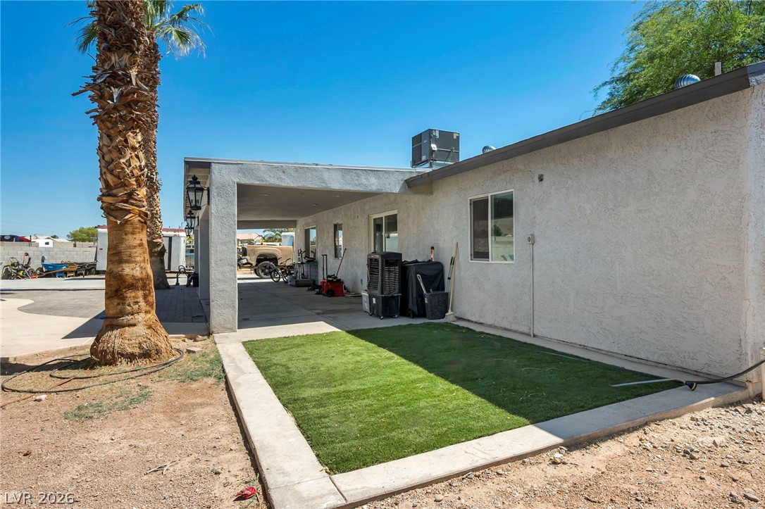 5882 Rio Tinto Way Las Vegas, NV 89110 - Photo 49 of 56 A sheltered patio area offers comfortable outdoor living with a small patch of vibrant green turf.