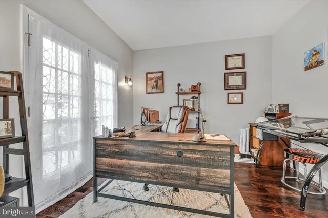 a view of a workspace with furniture and a window