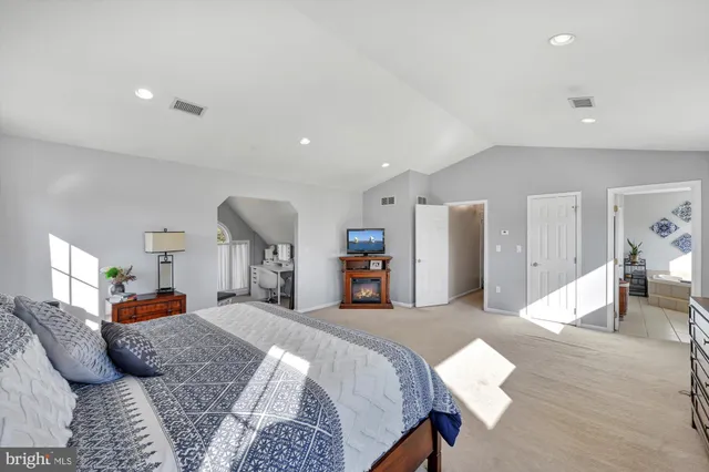 a bedroom with bed and a large mirror