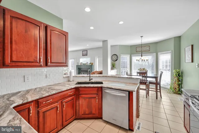 a kitchen with stainless steel appliances granite countertop wooden cabinets a sink and dishwasher