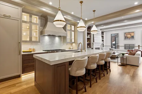 a view of a kitchen area with furniture and wooden floor
