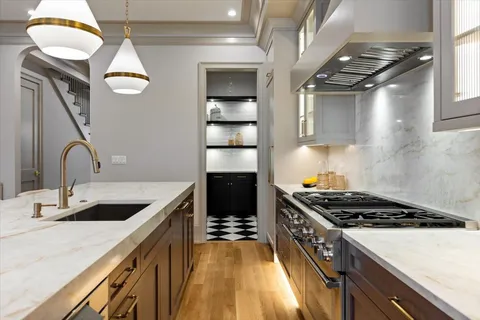 a kitchen with a sink stainless steel appliances and cabinets