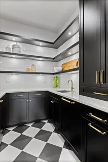 a kitchen with a counter space a sink appliances and cabinets