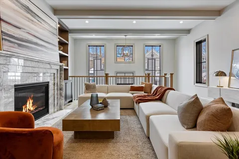 a bedroom with a bed a chandelier and couch