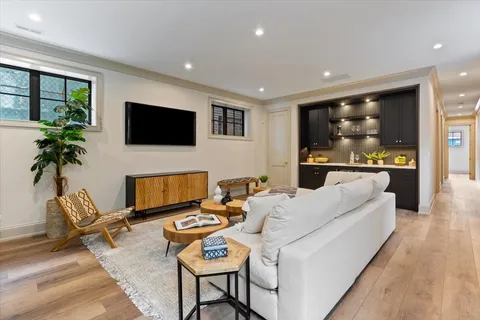 a living room with furniture potted plant and a window