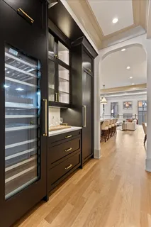 a view of hallway with livingroom and wooden floor