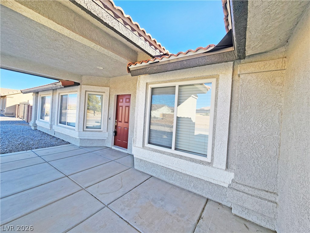 4591 Stoneham Street Pahrump, NV 89061 - Photo 3 of 42 A terracotta-tiled roof crowns this residence with a welcoming red entry door.
