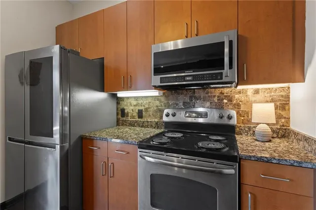 a kitchen with a stove microwave and refrigerator