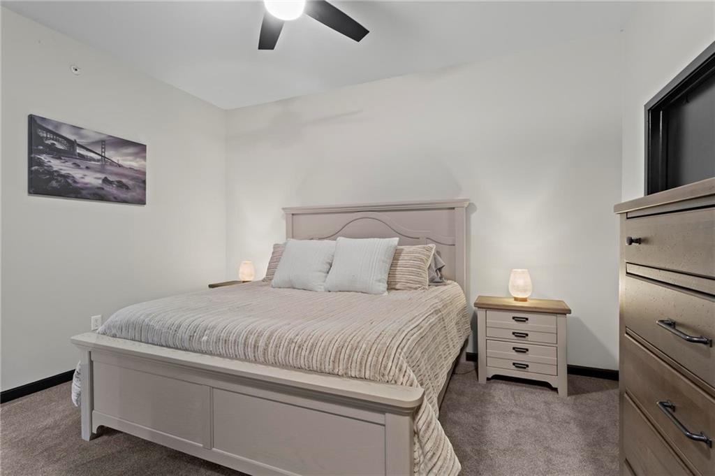 5300 Peachtree Road, Unit 4514 Atlanta, GA 30341 - Photo 17 of 38 a bedroom with a bed and a tv on the dresser