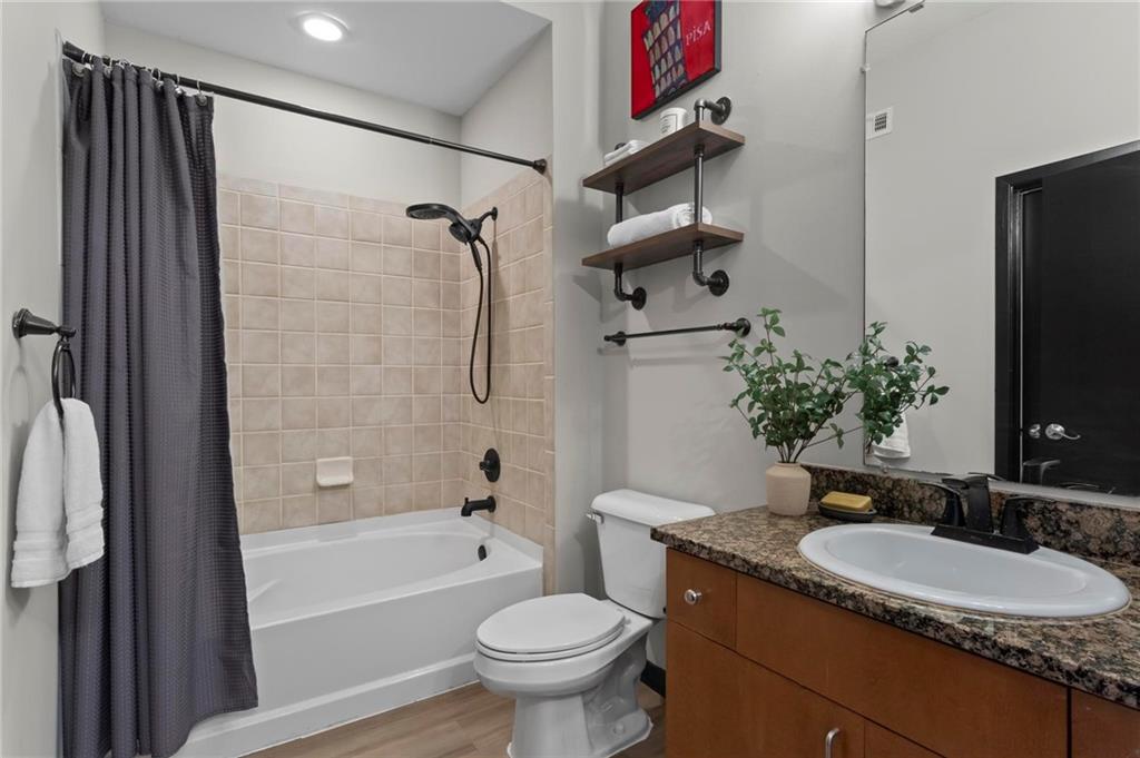 5300 Peachtree Road, Unit 4514 Atlanta, GA 30341 - Photo 21 of 38 a bathroom with a granite countertop sink toilet and shower