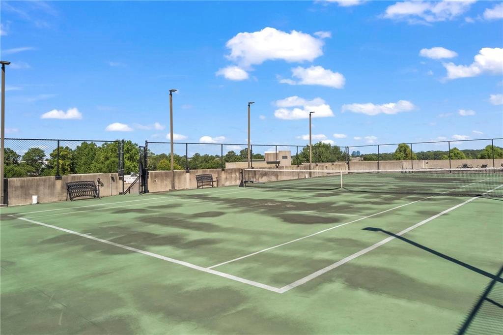 5300 Peachtree Road, Unit 4514 Atlanta, GA 30341 - Photo 26 of 38 a view of a tennis ground with large trees