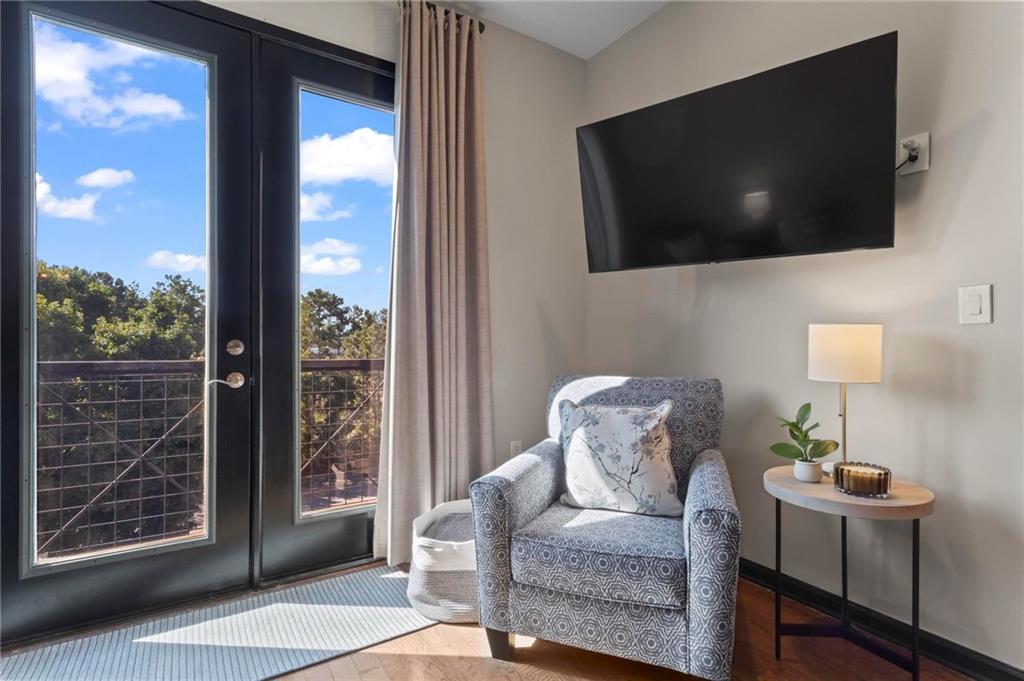 5300 Peachtree Road, Unit 4514 Atlanta, GA 30341 - Photo 7 of 38 a living room with furniture and a flat screen tv