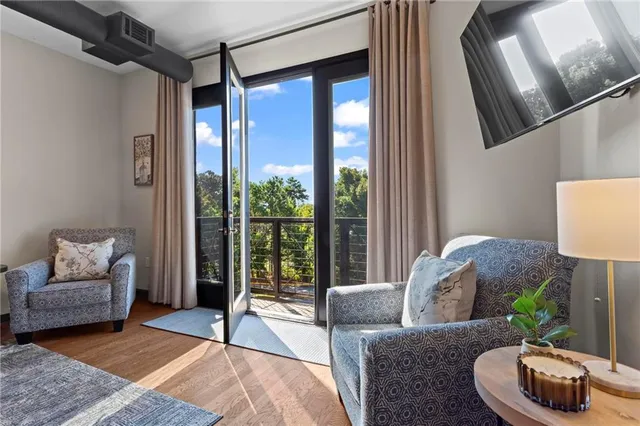 a living room with furniture and a floor to ceiling window