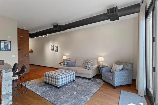a living room with furniture rug and wooden floor