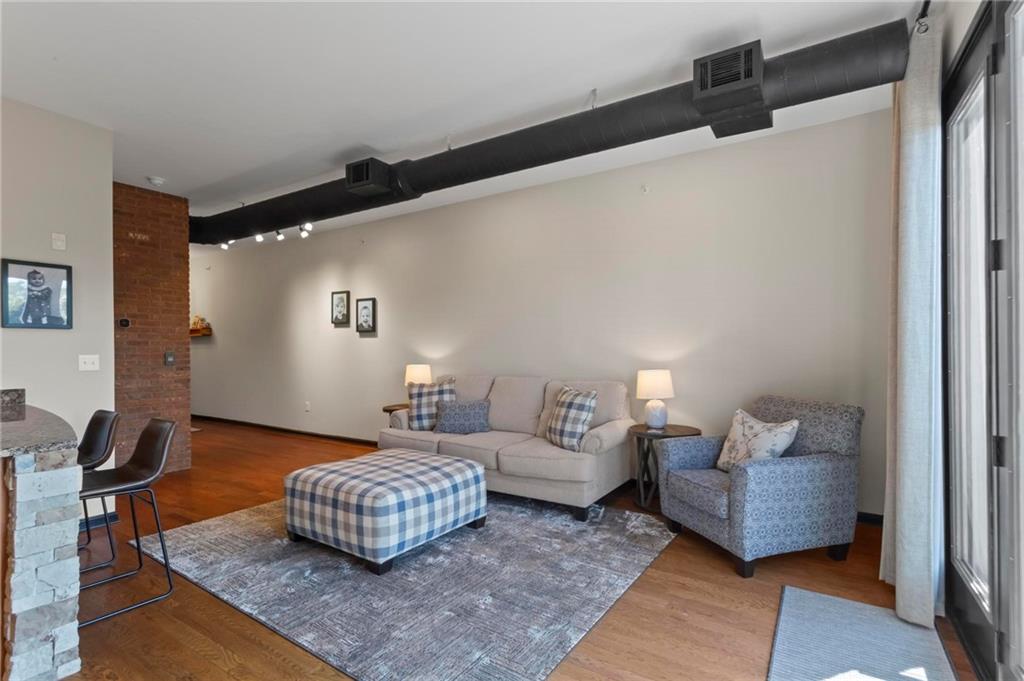 5300 Peachtree Road, Unit 4514 Atlanta, GA 30341 - Photo 9 of 38 a living room with furniture rug and wooden floor