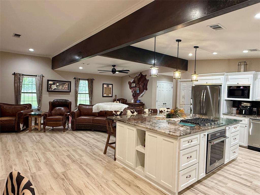 2007 Deep Water Road May, TX 76857 - Photo 8 of 40 a kitchen with stainless steel appliances granite countertop a stove and a sink