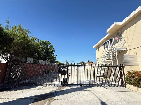 a view of a house with a wooden fence