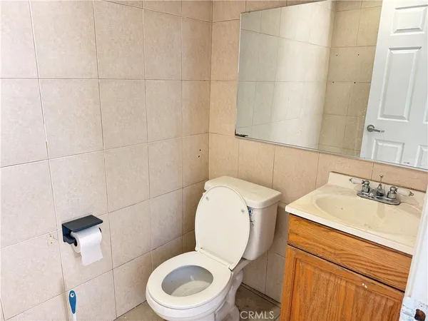a white toilet sitting next to a bathroom sink